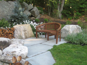 Granite patio and with firepit installed by landscape designer Nest Outdoors of Bedford NH