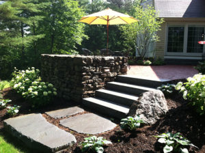 Large steppers leading to raised patio in Hopkinton NH by Nest Outdoors