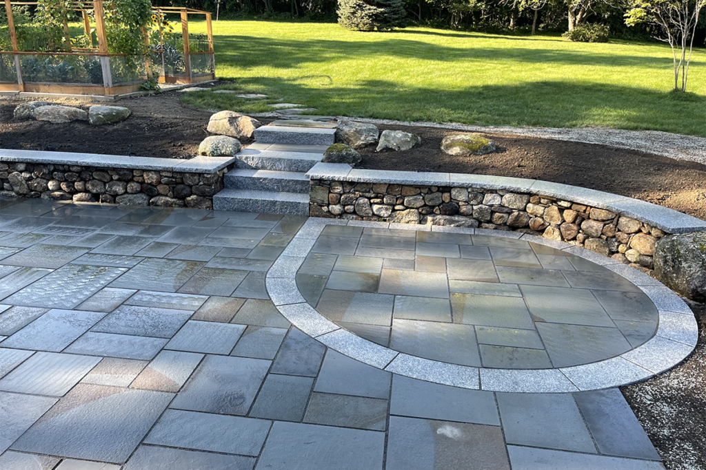 Landscape company Nest Outdoors designed this beautiful patio for a client in Bedford New Hampshire